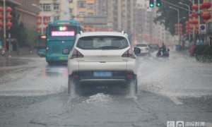 北京降瓢泼大雨 市民蹚水过马路